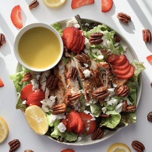 This hearty gluten-free salad features grilled chicken, butter lettuce, sliced strawberries, feta cheese and toasted pecans. Topped with lemon vinaigrette it is perfect for lunch or dinner.