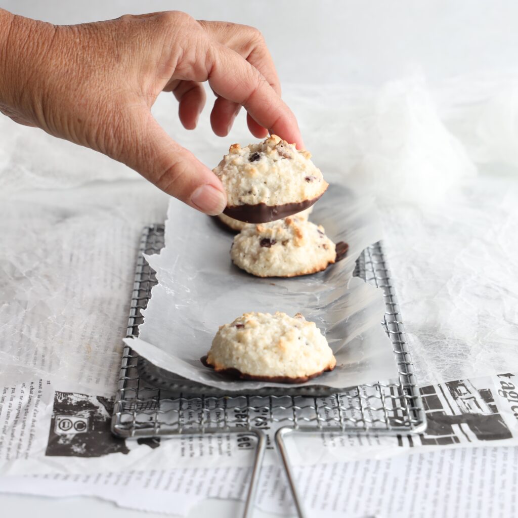 Gluten-Free Coconut Cranberry Macaroons are easy to make, delicious, crispy on the outside, chewy in the middle and the bottoms of the cookies are dipped in melted chocolate. It is baking season and these festive gluten-free coconut cranberry macaroons are perfect for the holidays.
