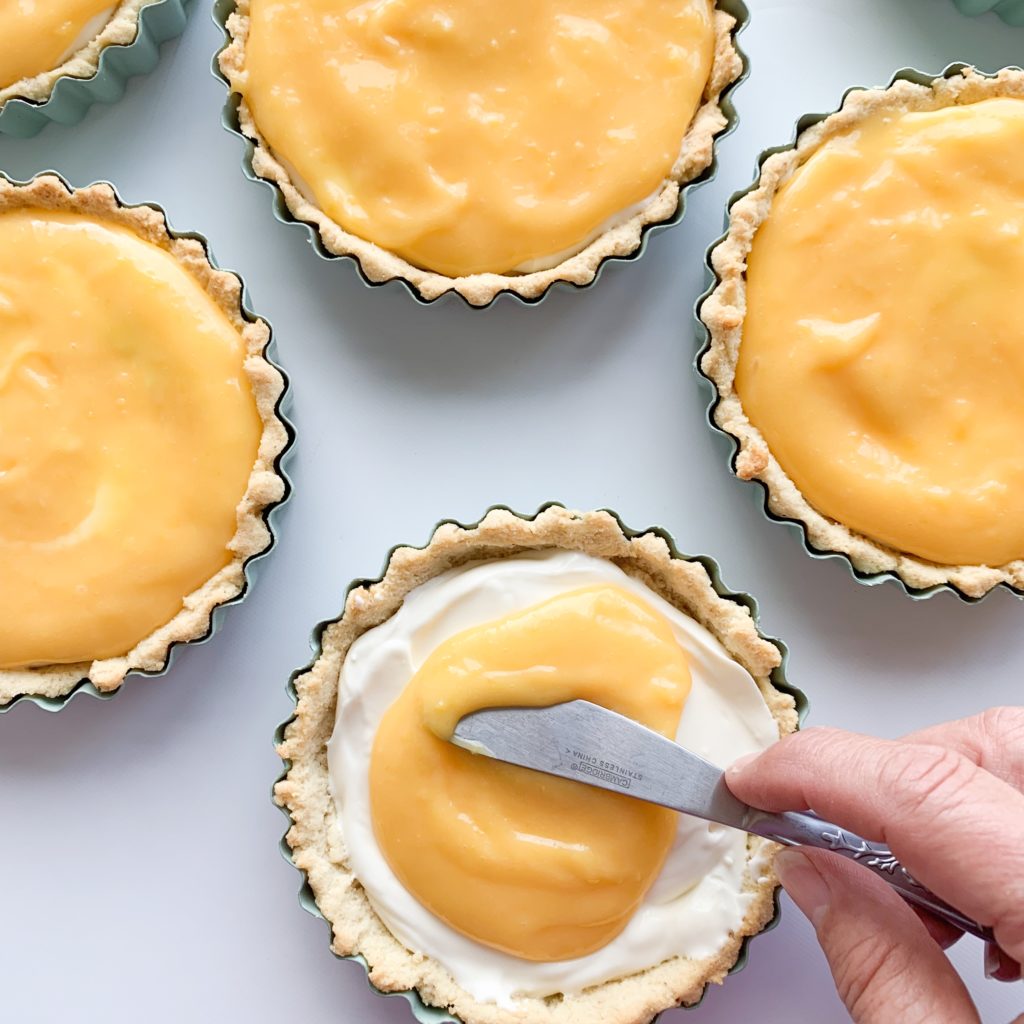 Keto and gluten-free no bake lemon curd cheesecake tarts that are tangy and delicious.