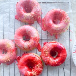 There are a few things better than a glazed donut. My recipe for gluten-free galaxy donut glaze takes icing to another level. Swirls of icing sugar, milk and food colouring layered on top of a gluten-free baked donut.