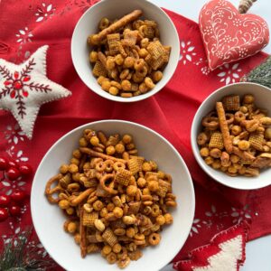 Gluten-free caramel Chex mix is a great holiday snack or food gift that is easy to make. It is so addicting and you will have a hard time only taking one handful to eat. Made with simple ingredients like gluten-free cereals, pretzels and peanuts and the whole recipe can be made in under 40 minutes.
