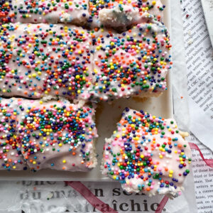 Indulge in holiday baking with these gluten-free sugar cookie bars that are topped with a creamy pink frosting and sprinkles. An easy to make, delicious sweet treat that is perfect for any occasion. The same great taste of a sugar cookie without the chilling, rolling and cutting out of shapes.