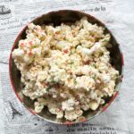 This white chocolate peppermint popcorn is easy to make, delicious and the perfect gluten-free treat for the holidays. Only 3 ingredients needed, melted white chocolate and crushed gluten-free candy canes is poured over lightly salted popcorn and mixed. Perfect for holiday parties, food gifts or snacking at home while watching Christmas movies.
